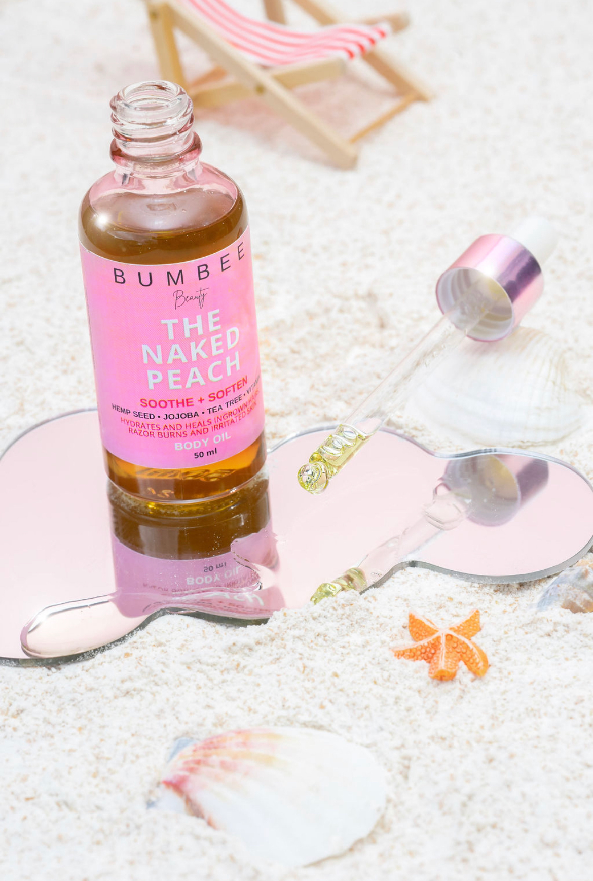 Naked Peach body oil placed on a sandy beach setting, showcasing its ability to alleviate razor burn on the bikini line. The image evokes a sense of confidence in wearing a swimsuit, with the product promising smoother and irritation-free skin for a comfortable beach experience